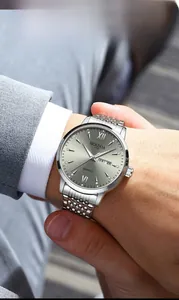 Close-up of men's business watch with silver dial, roman numerals and day-date display