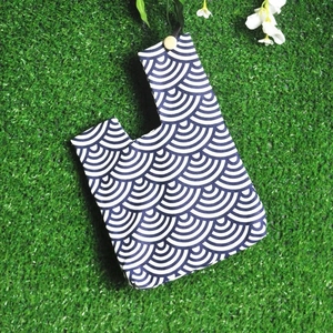 Close-up of blue and white seigaiha wave pattern on a knit cotton wristlet bag