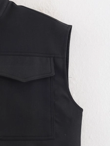 Detailed view of black utility vest featuring twill fabric and flap chest pocket