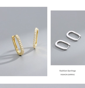 Detail view of gold and silver S925 sterling silver earrings with paved cubic zirconia stones