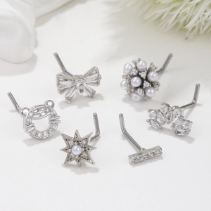 Detailed set of 6 silver nose studs featuring bow, star, and pearl designs on white background