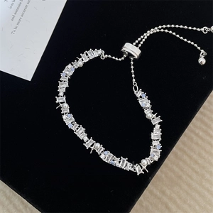 Elegant silver star bracelet with zircons and pearls on black velvet display