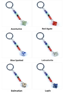 Macro detail of six natural stone star keychains including agate and lapis lazuli