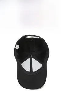 Detail showing breathable mesh back and care label of a black polyester baseball cap