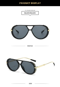 Close-up of classic double-bridge pilot sunglasses with black frame and gold metal temples