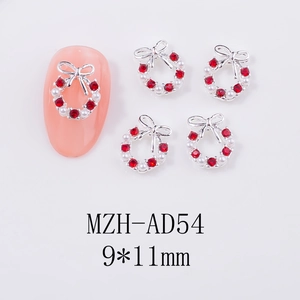 Close-up of 9x11mm Christmas wreath nail art charm with red rhinestones and pearls