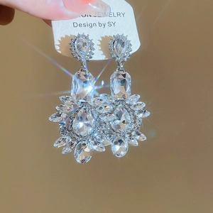 Detailed view of silver long drop tassel earrings with sparkling zircon crystals