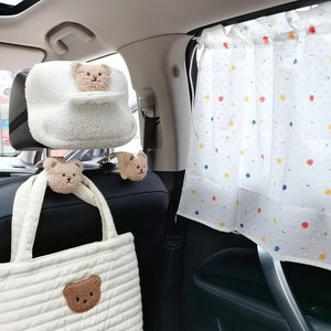 Plush bear car tissue holder and headrest hooks set in cozy car interior scene