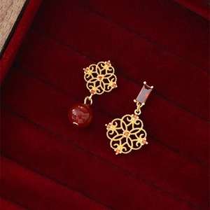 Vintage gold asymmetric earrings with hollow floral design and deep red gemstones