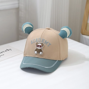Close-up of cotton baby baseball cap featuring bear patches and ACADEMY embroidery
