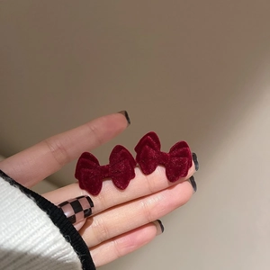Red velvet bow stud earrings with soft fur balls for festive winter jewelry styles