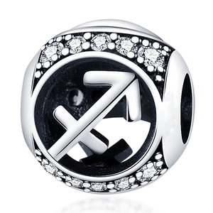 Macro view of silver Sagittarius zodiac charm with shimmering cubic zirconia stones