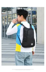 Lightweight foldable black hiking backpack with breathable mesh straps shown in outdoor use