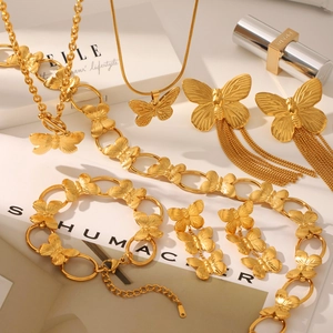Golden butterfly jewelry set featuring stainless steel necklaces, bracelets and earrings