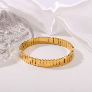 Vertical striped oval hollow 18K gold plated stainless steel bracelet on white silk