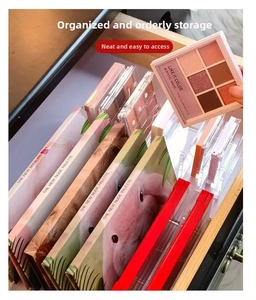 Close-up of clear acrylic drawer organizer showing vertical dividers for eyeshadow palettes