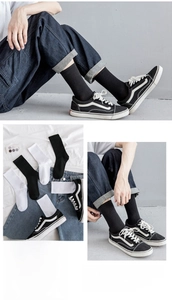 Detail of ribbed crew socks in black and white with premium combed cotton texture