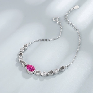 Detailed macro view of S925 silver bracelet featuring pink teardrop stone and round zircons