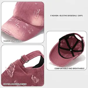 Distressed washed cotton baseball cap with ripped details and adjustable buckle in dusty pink