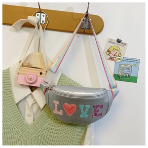 Detail of silver sequined kids fanny pack with LOVE patches and rainbow adjustable strap