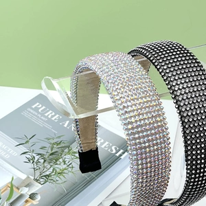 Detail of rhinestone headbands in black and silver on transparent acrylic display stand