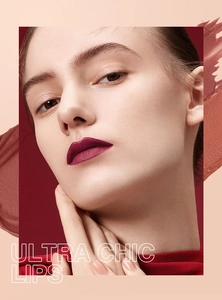 Detail shot of matte deep berry lip gloss and liner applied on model with color swatch