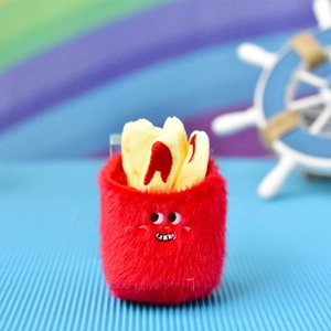 Close-up of cute plush French fries pendant with fluffy red container and yellow fries