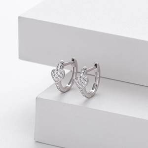 Macro detail of S925 sterling silver heart hoop earrings with pavé set cubic zirconia