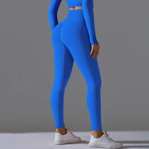 Detail view of high waist bright blue yoga set showing seamless shaping and peach lift effect