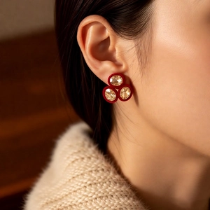 Macro detail of vintage oval earrings featuring red velvet border and champagne crystals