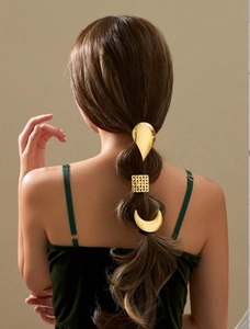 Three-piece gold metal hair clips set shown on a braided ponytail from behind