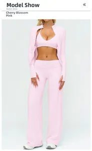 Three-piece pink yoga set featuring zip-up jacket, sports bra, and wide-leg track pants