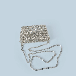 Detailed view of silver hollow weave beaded crossbody bag with a long metal chain strap
