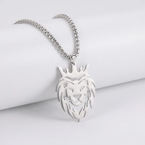 Detailed view of a silver lion head pendant with crown on a square link chain