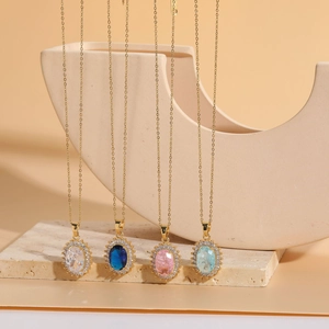 Detailed view of 14K gold-plated oval resin necklaces with colorful gemstone pendants