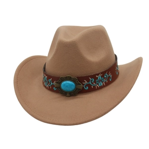 Close-up of camel felt cowboy hat with embroidered band and turquoise metal buckle