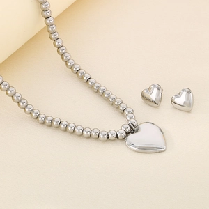 Polished silver heart pendant necklace and matching stud earrings jewelry set display