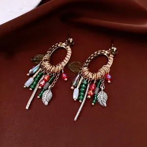 Ethnic bohemian drop earrings with gold hollow leaf frames and colorful beaded tassels
