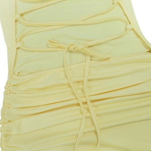 Close-up of sexy backless criss-cross tie and ruched detail on a pale yellow maxi dress