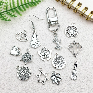 DIY jewelry making kit with vintage silver charms including hexagram and tower shapes
