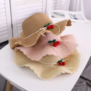 Three sun hats with wavy brims, decorative knitted cherries and white bowknots