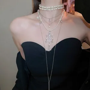 Elegant multi-layered necklace with pearl beads and rhinestone cross pendants for women