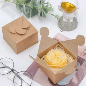 Detail of kraft paper gift box with petal-shaped closure and candle storage capacity