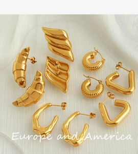 Flat lay of vintage gold plated croissant textured and geometric earrings set