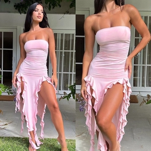 Detail of pink strapless bodycon dress with ruched fabric and ruffled hemline