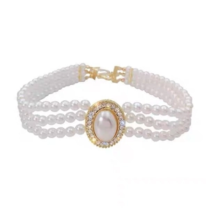 Three-row pearl choker necklace with large oval centerpiece and sparkling crystal halo