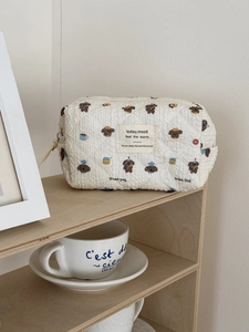 Detailed macro of a quilted cotton cosmetic bag with a cute puppy print on a wooden shelf