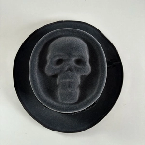 Top view detail of 3D skeleton embossing on black felt cowboy hat with grim reaper design