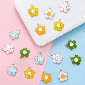 Macro detail of multi-colored enamel flower pendants for DIY jewelry with metal rings