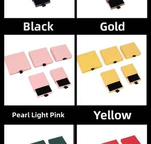 Macro view of drawer jewelry boxes in black, gold, pink, and yellow with soft foam pads
